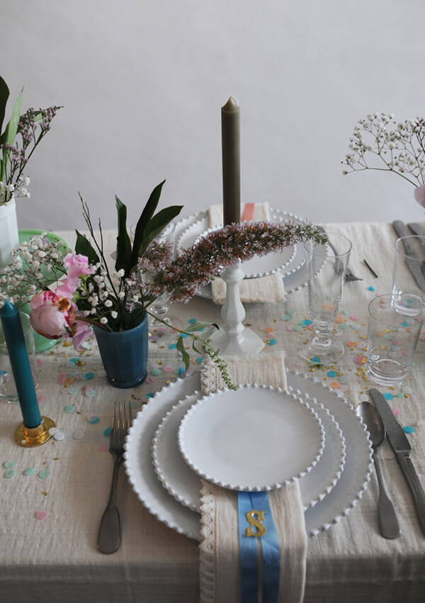 A close up of a table setting with the Costa Nova Pearl White serveware for the wedding table.
