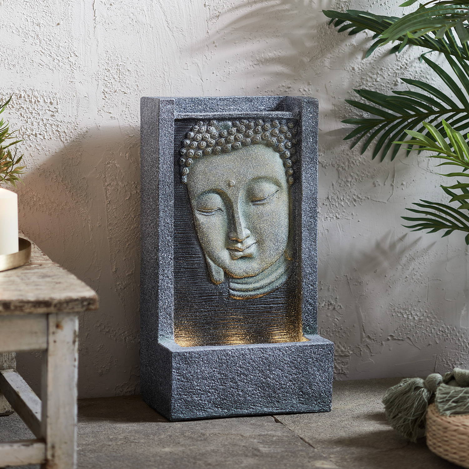 Light up Buddha water feature sat on patio and illuminated 