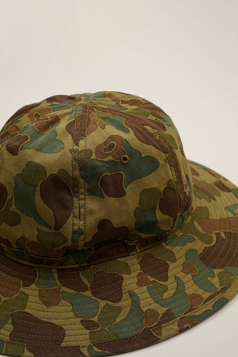 Camo bucket hat displayed on a neutral background.