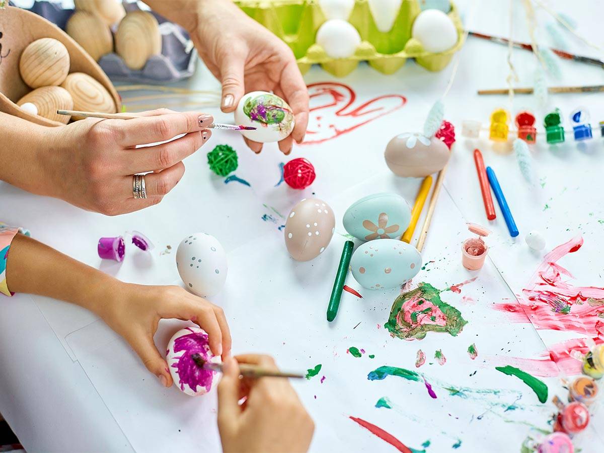 Mother and child painting eggs for Easter by WholeWoodPlayhouses