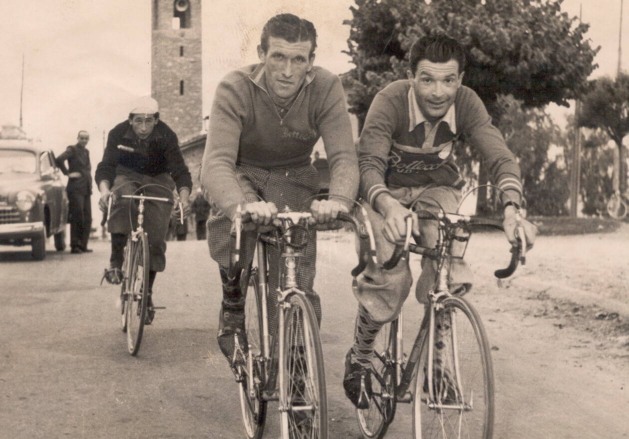 Vintage picture of cyclists riding Pinarello in olden times