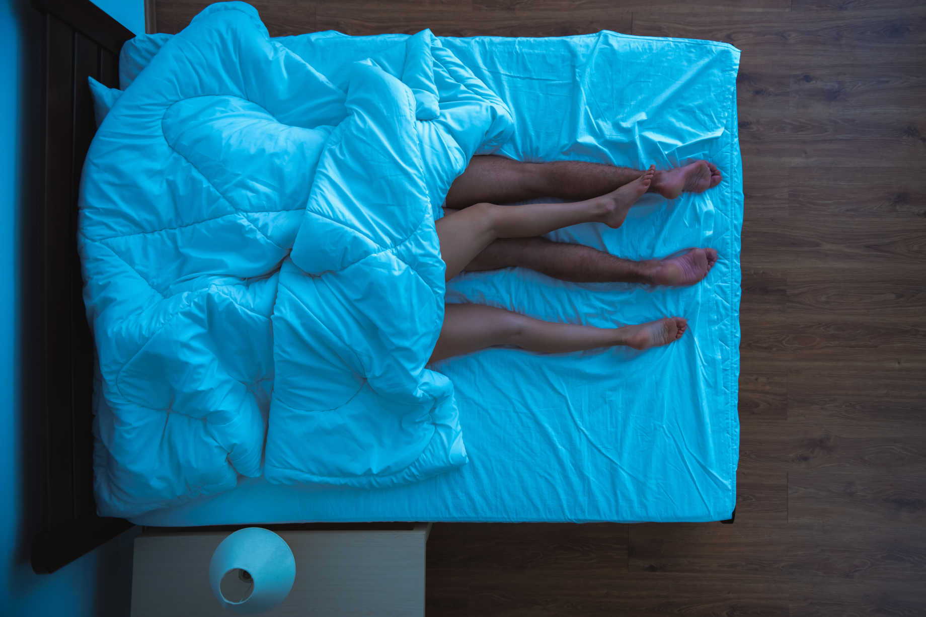 A sexy couple lying on a medium-firm mattress.