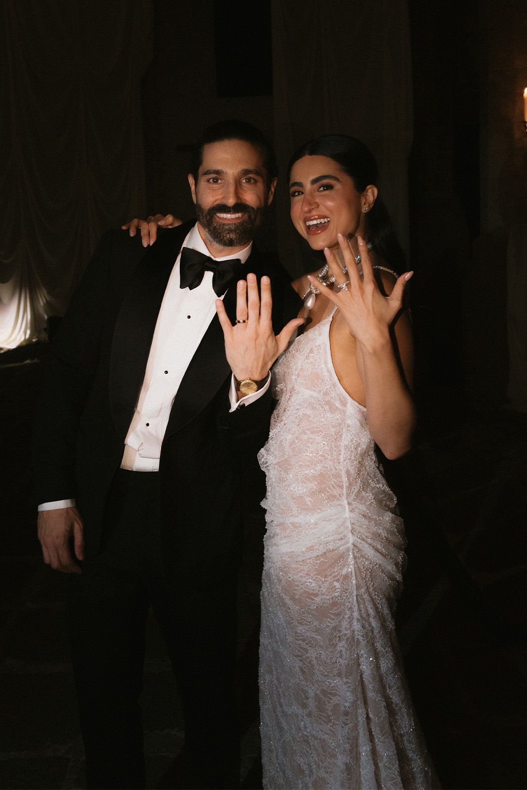 Bride and groom showing off their wedding rings after celebrating their wedding