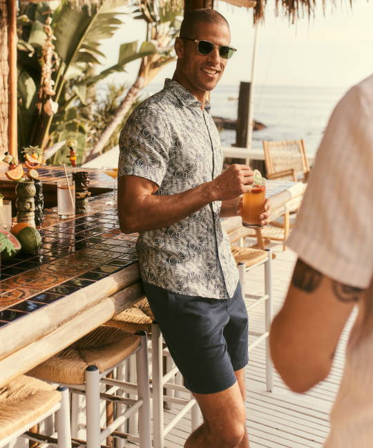 Model is wearing UNTUCKit DRISCOLL button down and Whitley shorts.