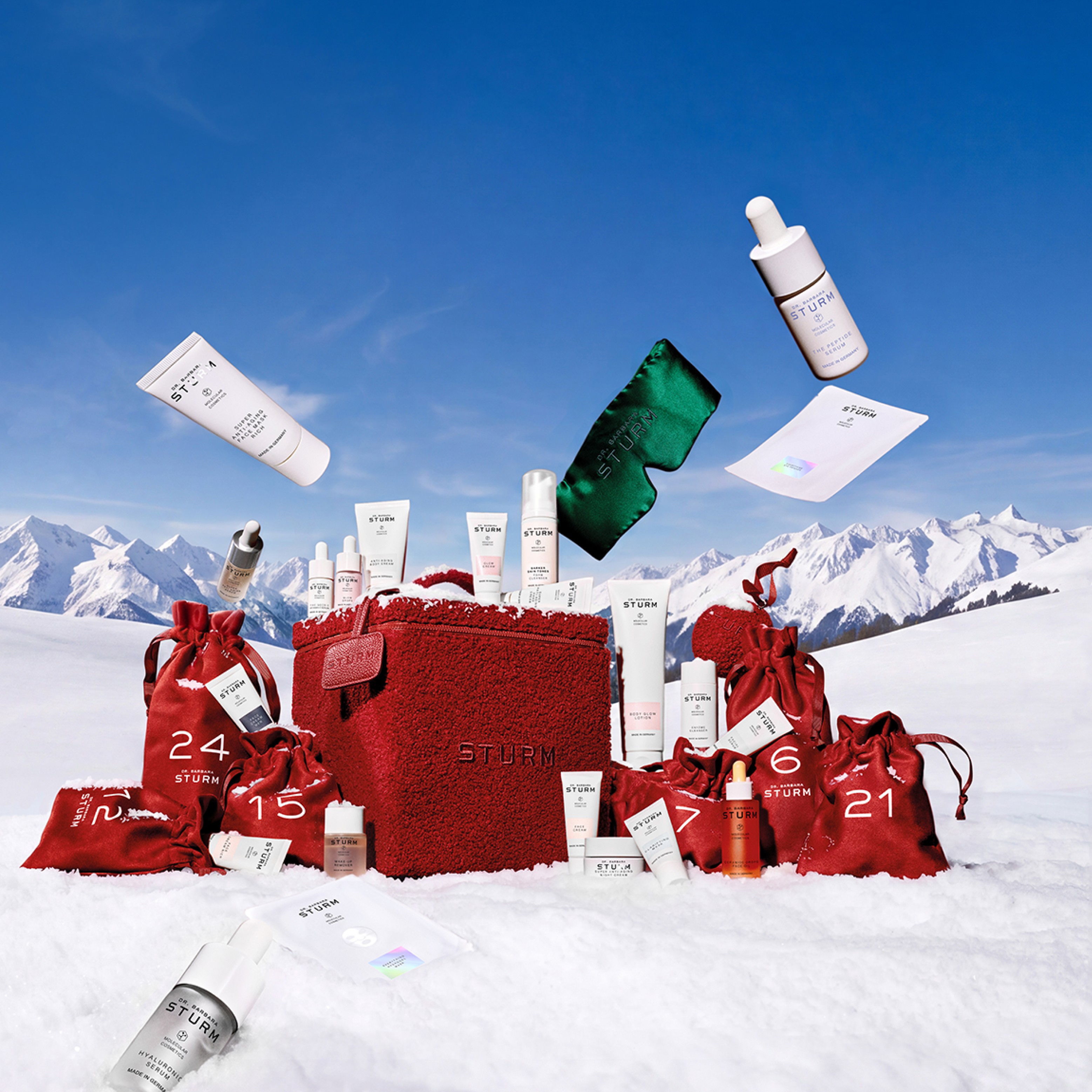 Christmas gifts and skincare products in a snowy mountain landscape.