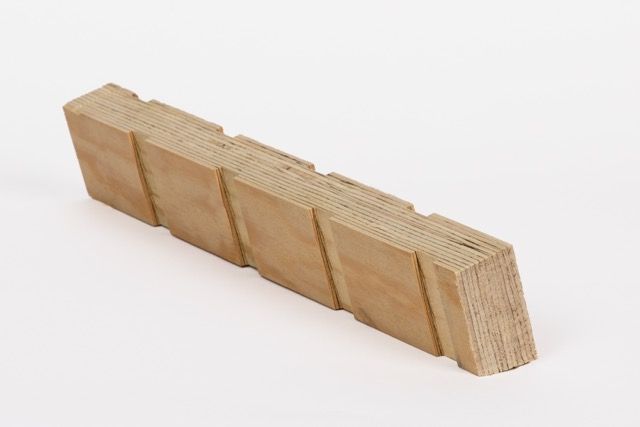 Wooden block with multiple sections arranged in a linear formation.