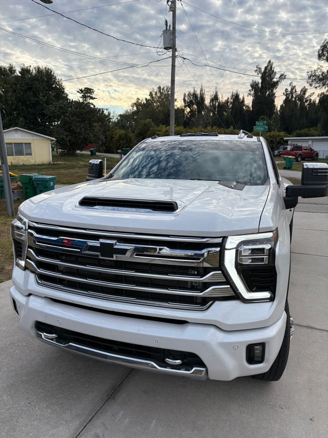 Side profile of 2025 Chevy Silverado 3500HD High Country dually with Stealth 5 Gallon Spare Tire Delete train horn install HornBlasters gallery photo 2
