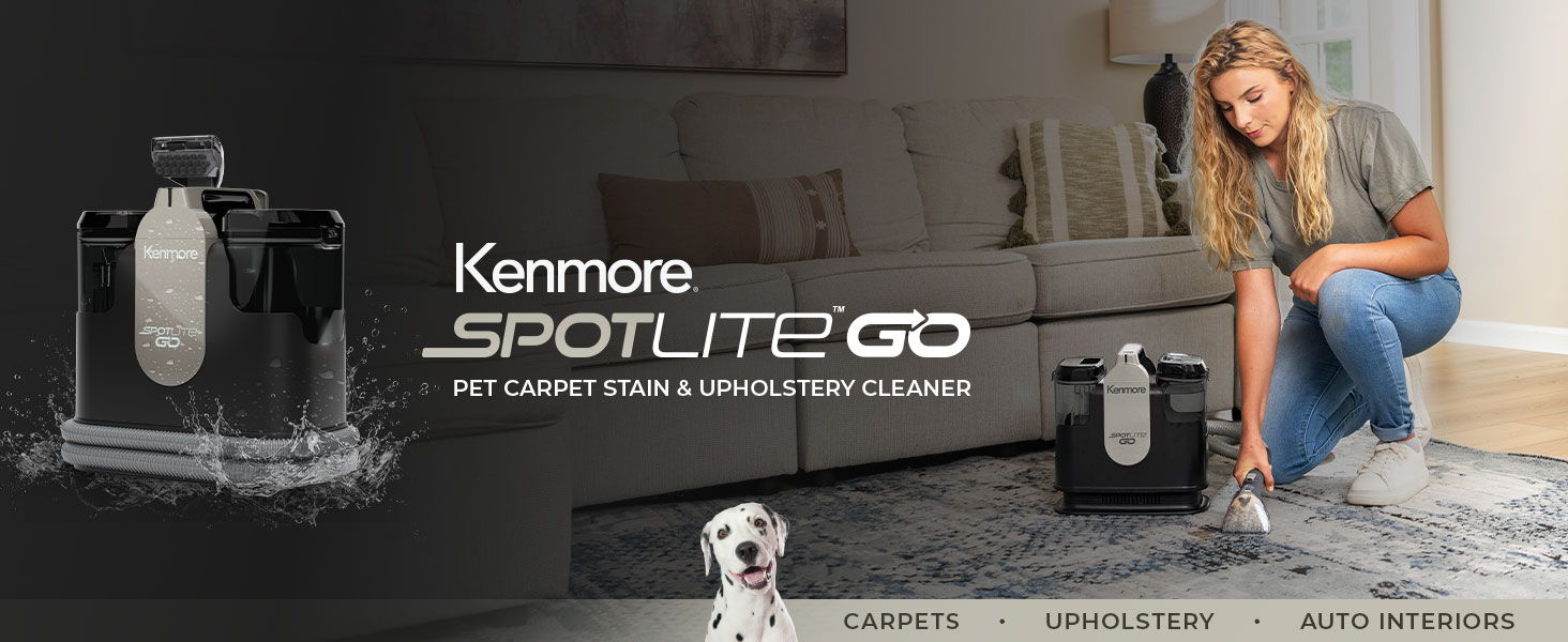 A woman kneels down in front of a couch to clean a rug with the Kenmore Spotlite GO