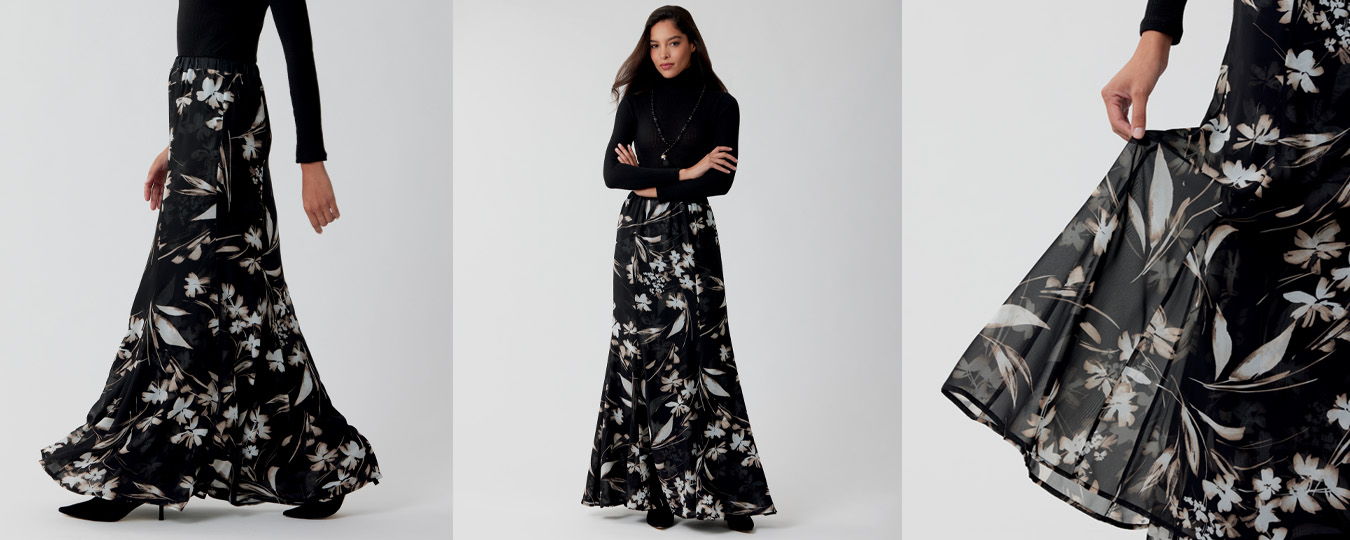 A woman in a floral black skirt poses and twirls.