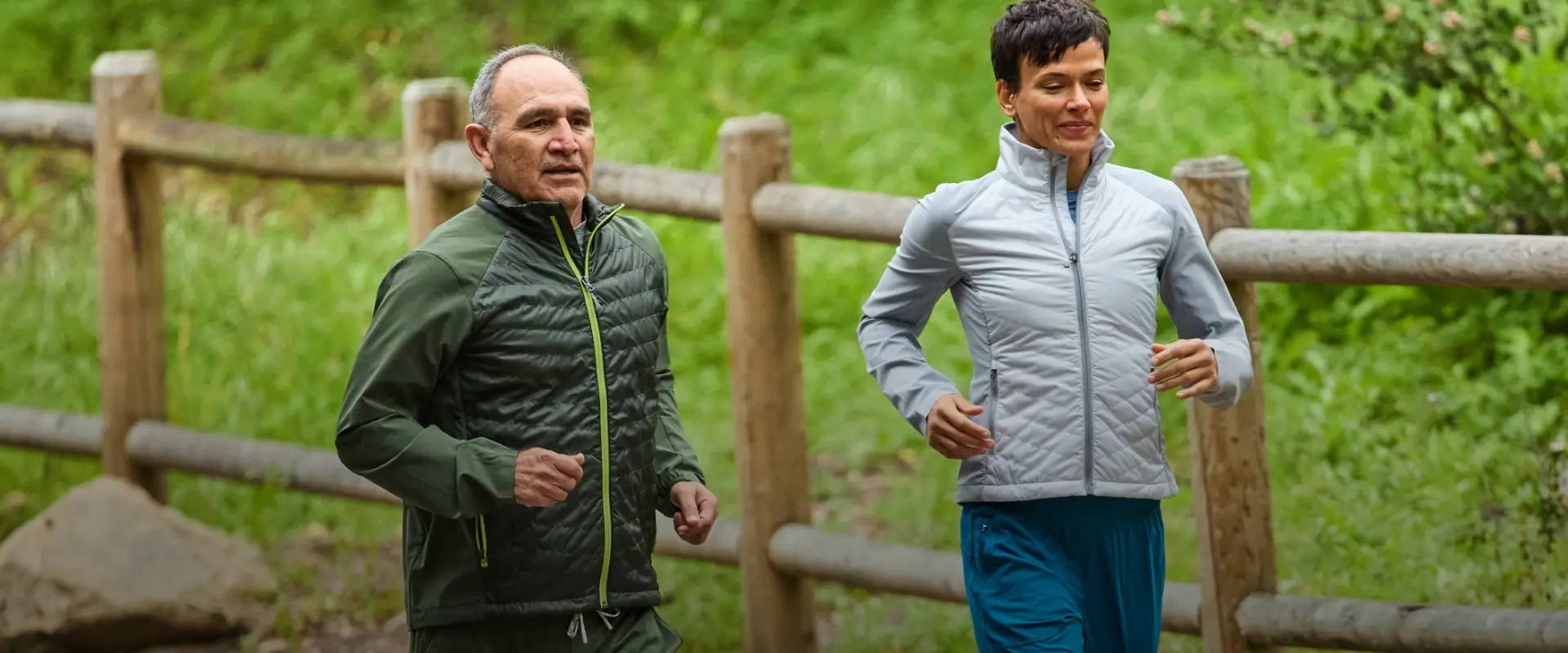 man and woman runners wearing Nathan Sport Navigator Hybrid Jackets