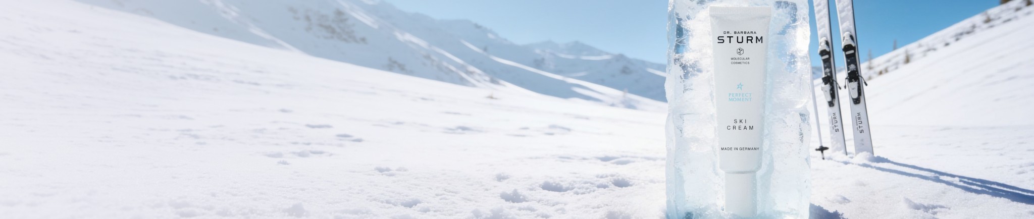 Skier on snowy mountain landscape with ice formations and blue sky.