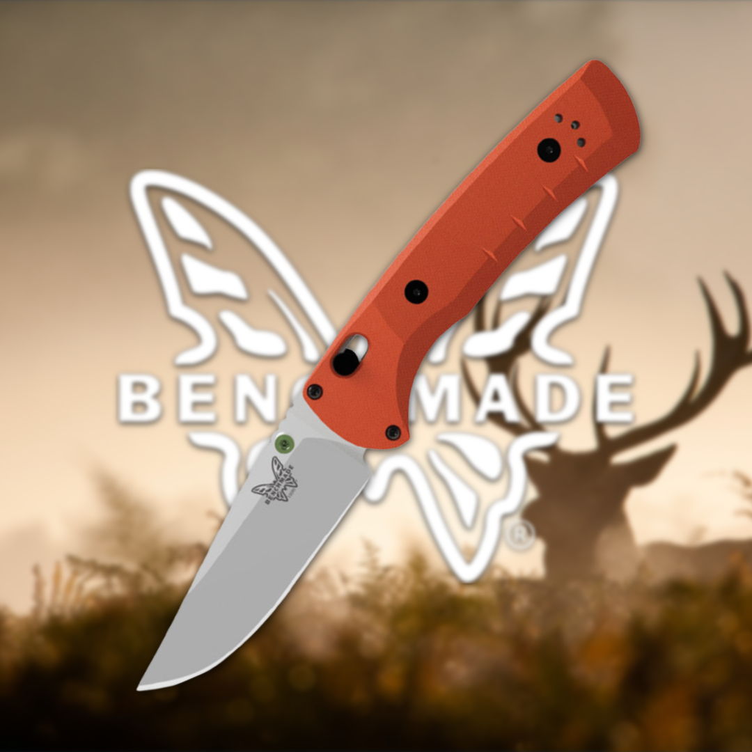 Orange-handled folding knife with a silver blade and logo in background.