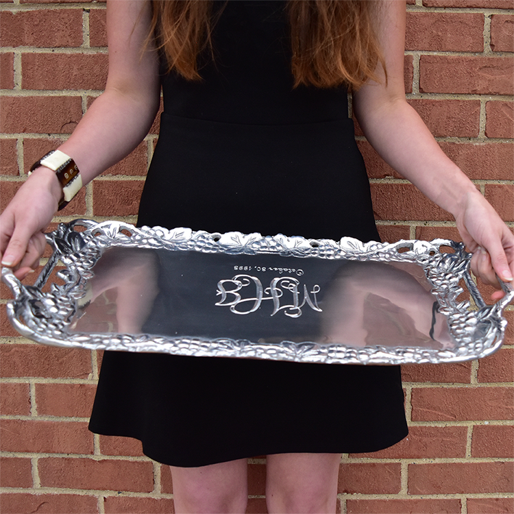 A woman holding a silver tray.