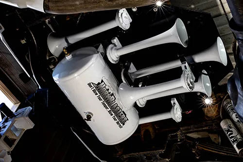 White HornBlasters train horn and air tank mounted under truck