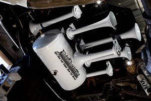 White HornBlasters train horn and air tank mounted under truck