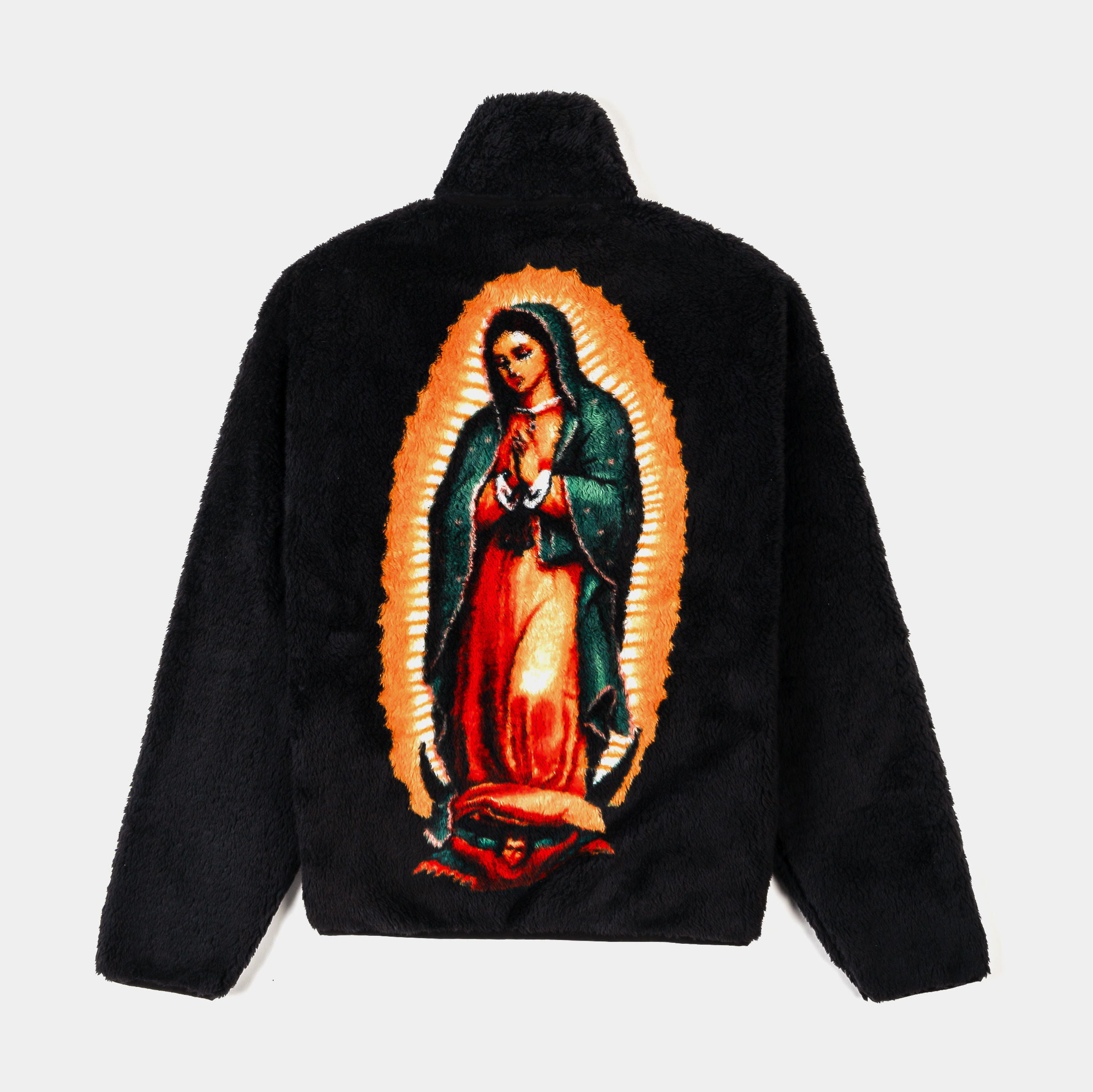 Black faux fur jacket with religious patches and zippered pockets.