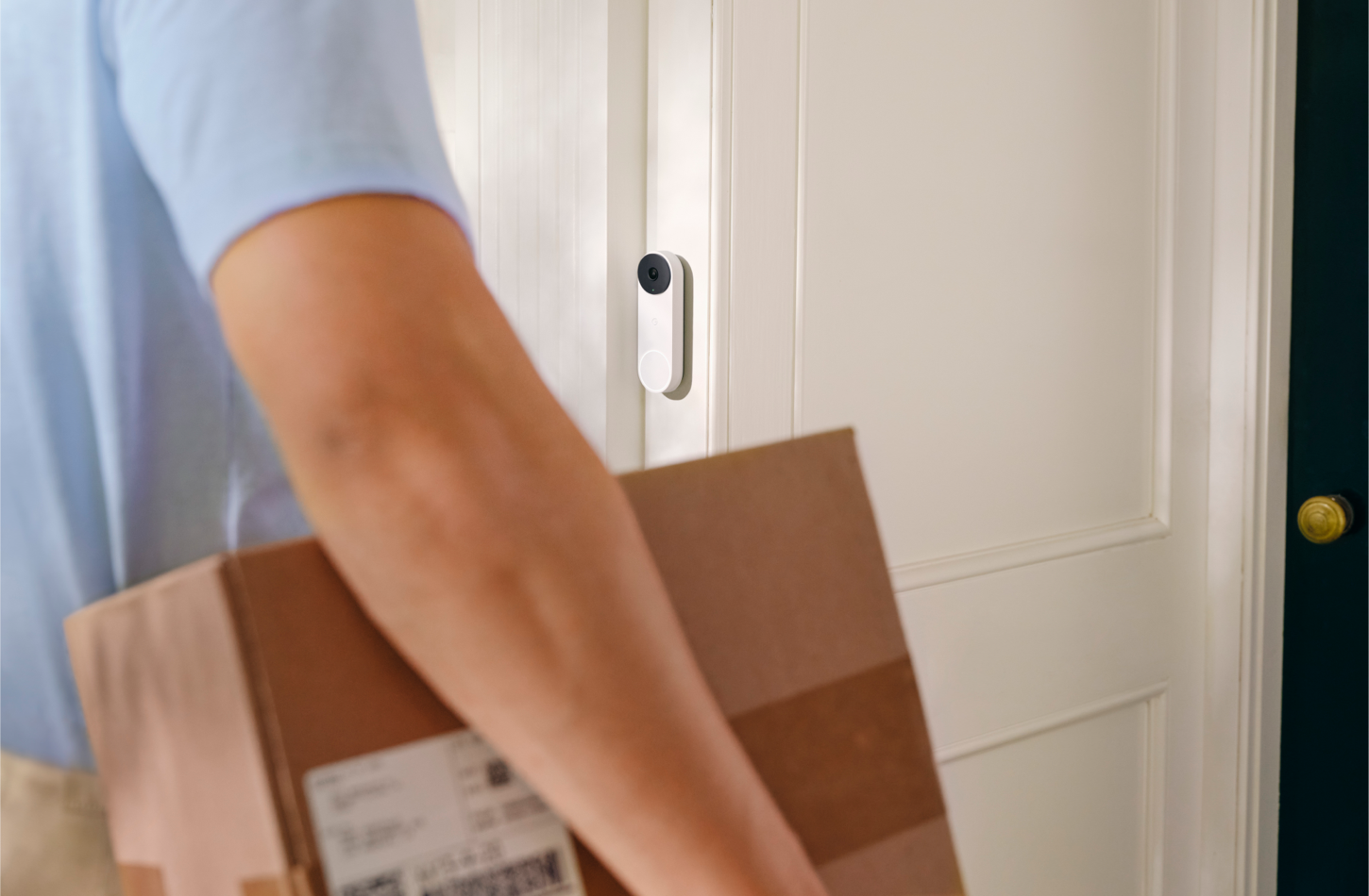 Delivery person ringing a Nest smart doorbell
