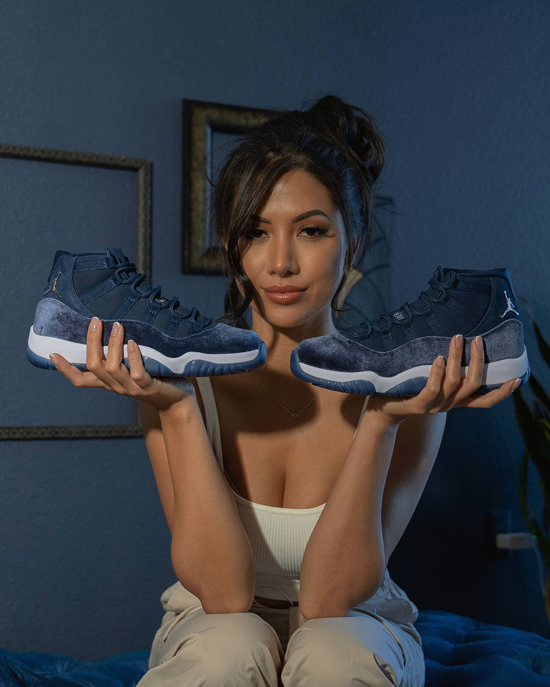 female model holding aj11 retro midnight navy