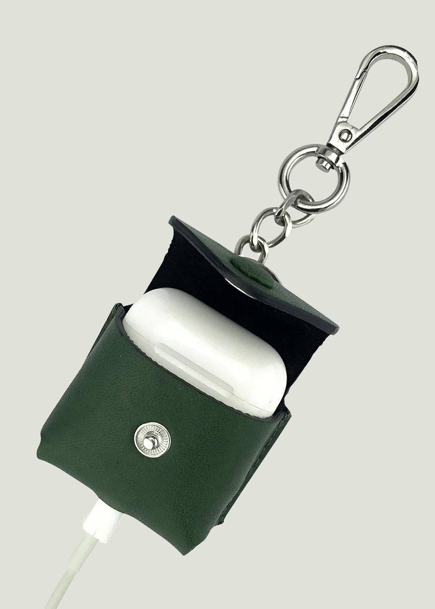 a green airpod charging case keychain, shown open with the charger plugged in the bottom