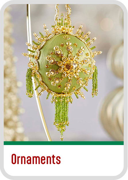 A decorative green ornament with intricate golden and bead designs. Christmas Ornament kits