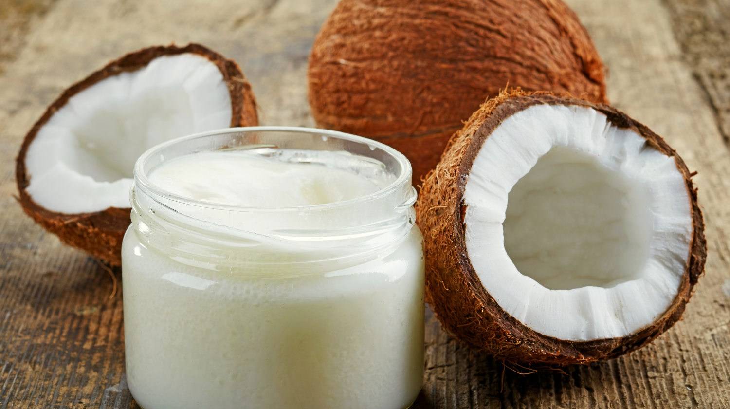 Featured | Coconut oil and fresh coconuts on old wooden table | Why Coconut Oil Makes A Great Topical Antifungal