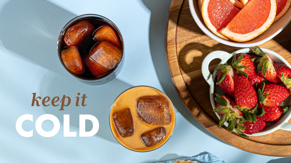 Two glasses of Grady's cold brew served over ice with fresh fruit and the words keep it cold.