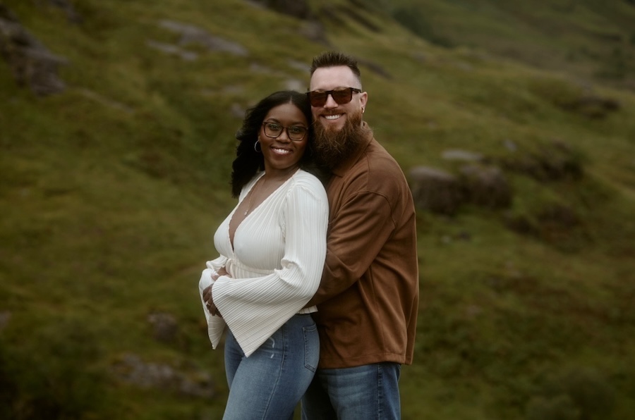 engaged couple hugging in scottish highlands