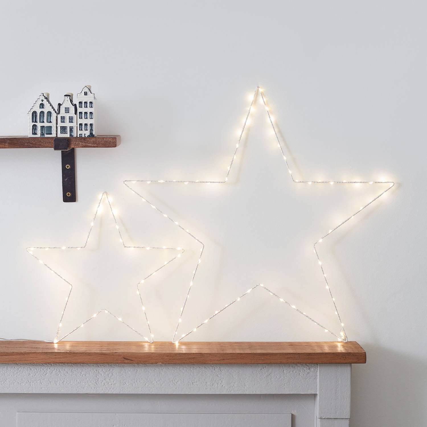 Osby star duo on a bedroom shelf against a white wall.