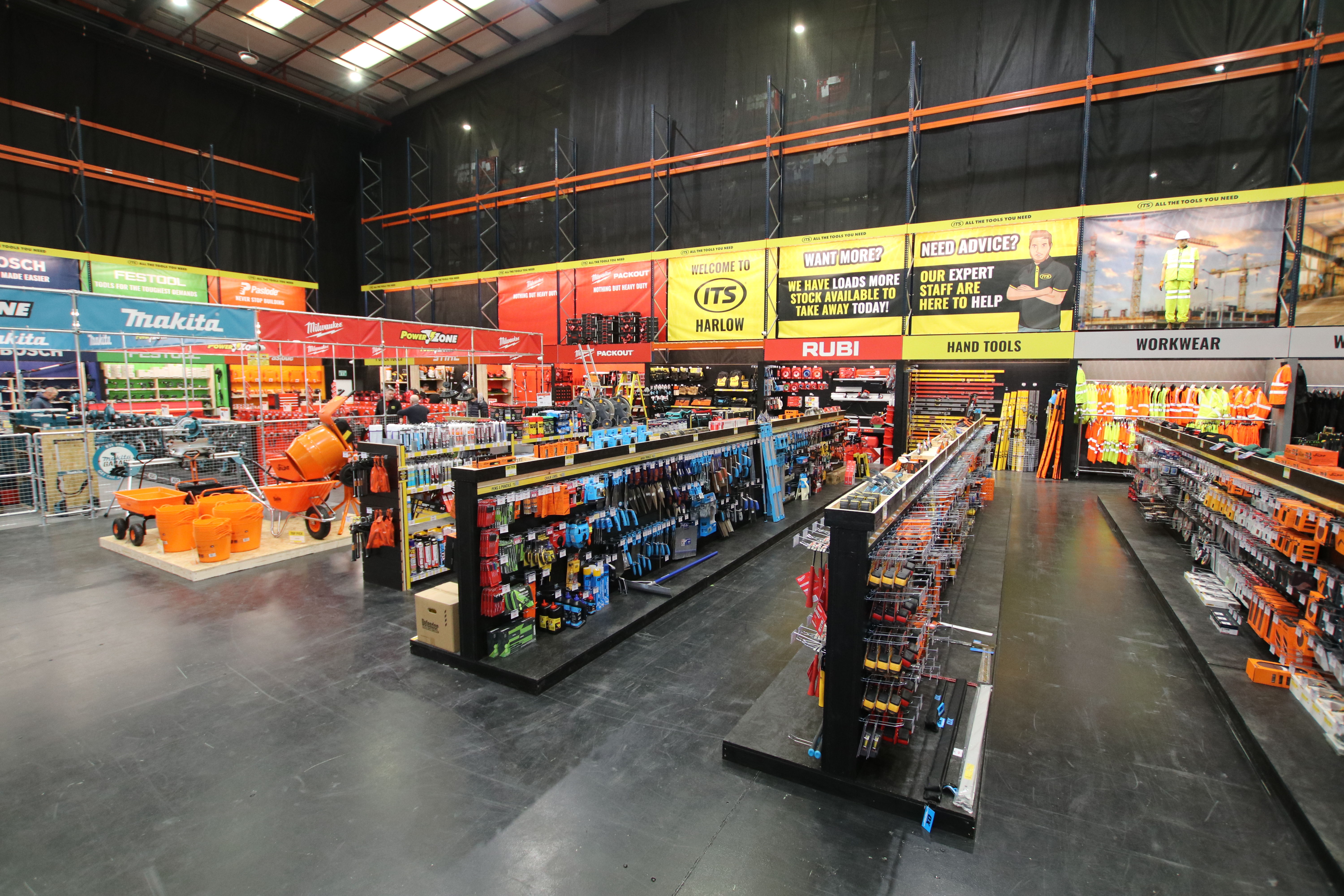 A brightly lit hardware store with colorful displays and various tools.