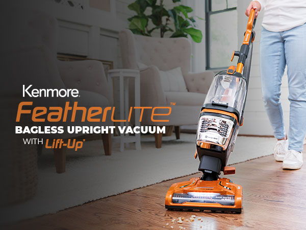 Kenmore Featherlite bagless upright vacuum cleaner in use on a wooden floor.