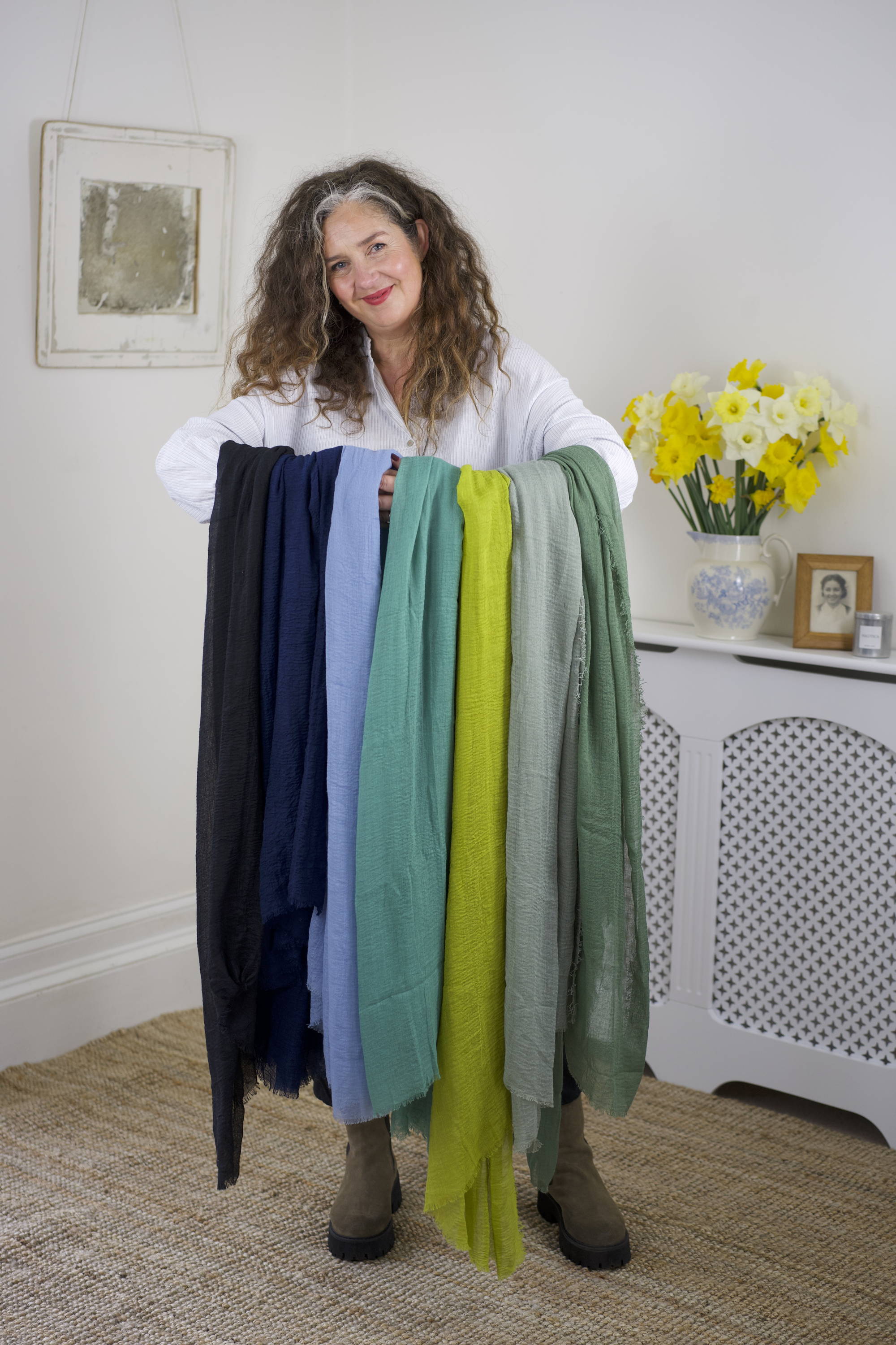 Emma Vowles holding an array of different coloured scarves