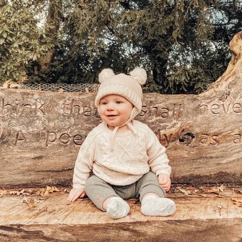 George aged 6 months sitting on a wooden bench