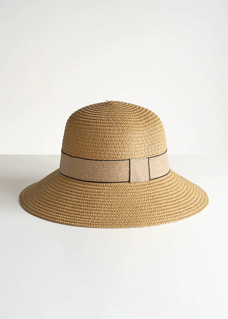 A wide brimmed paper straw hat with ribbon detailing