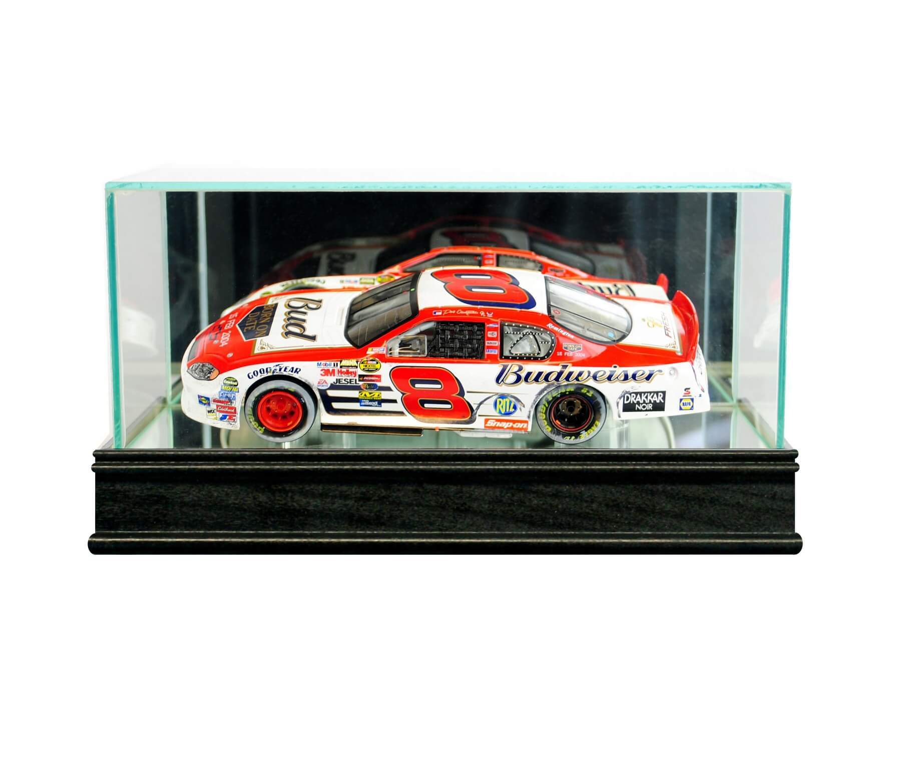 Diecast model car displayed in a glass case on a wooden base.