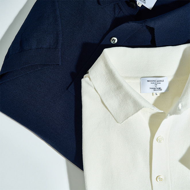Two polo shirts, one navy blue and one off-white, laid flat.