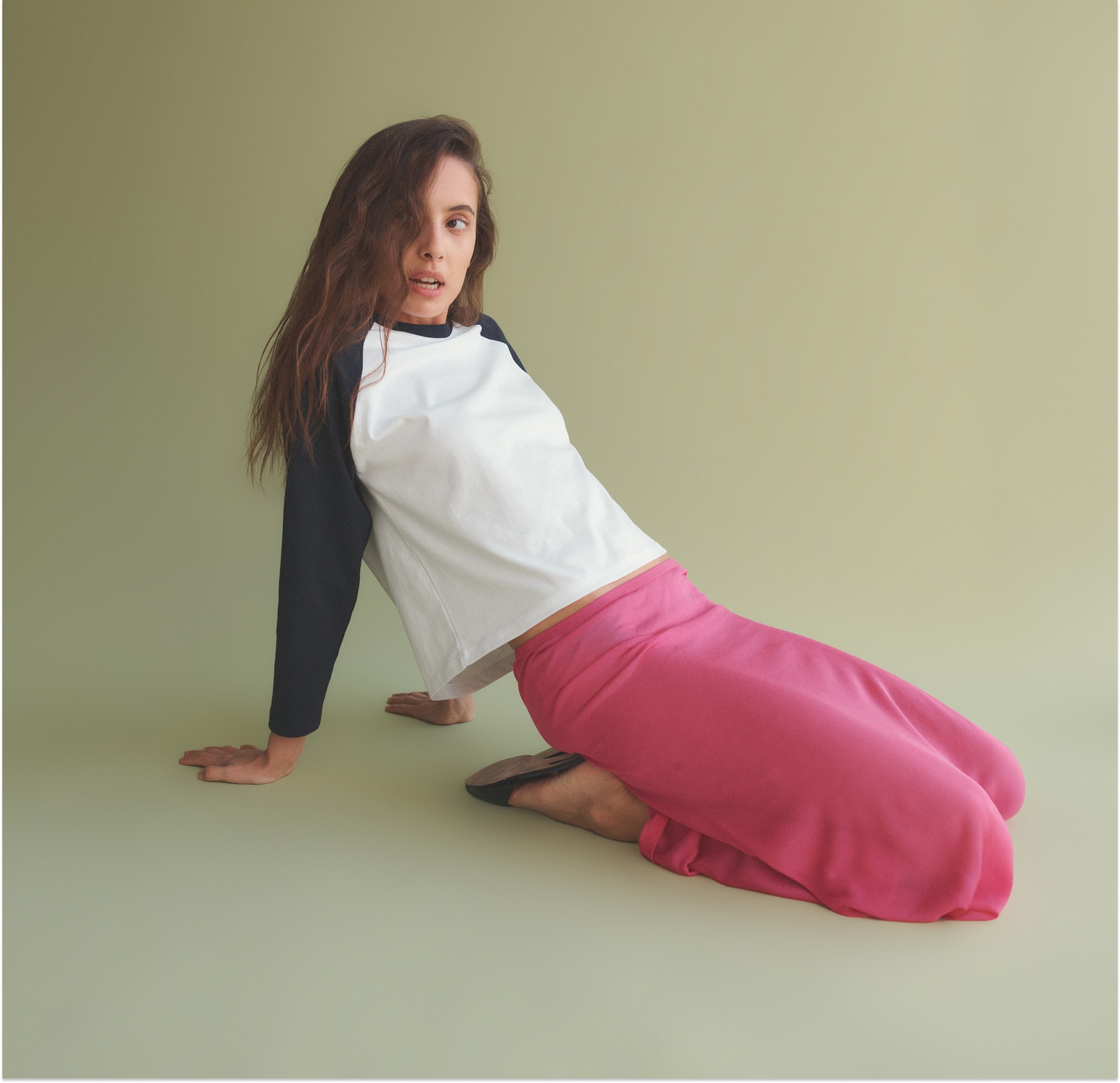 woman on knees with arms behind