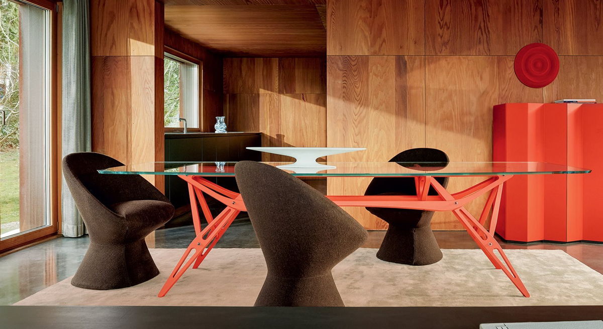 Modern zanotta dining room with a glass table and unique chairs.
