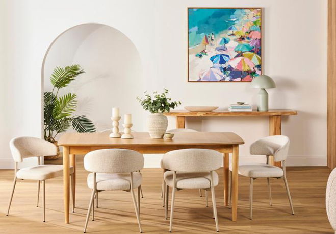 Modern dining room with wooden table, chairs, and colorful artwork on the wall.