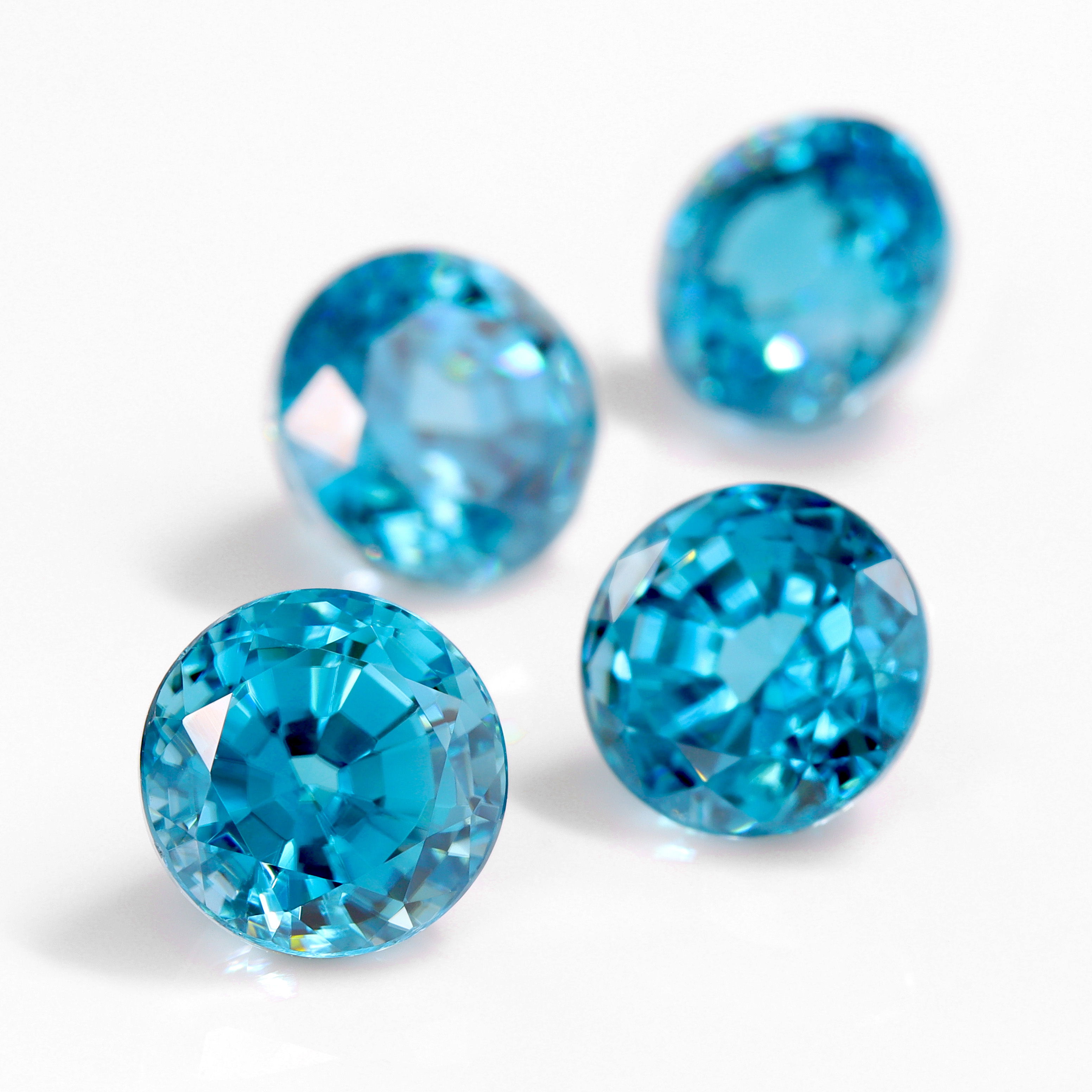 Four blue gemstones on a white background.