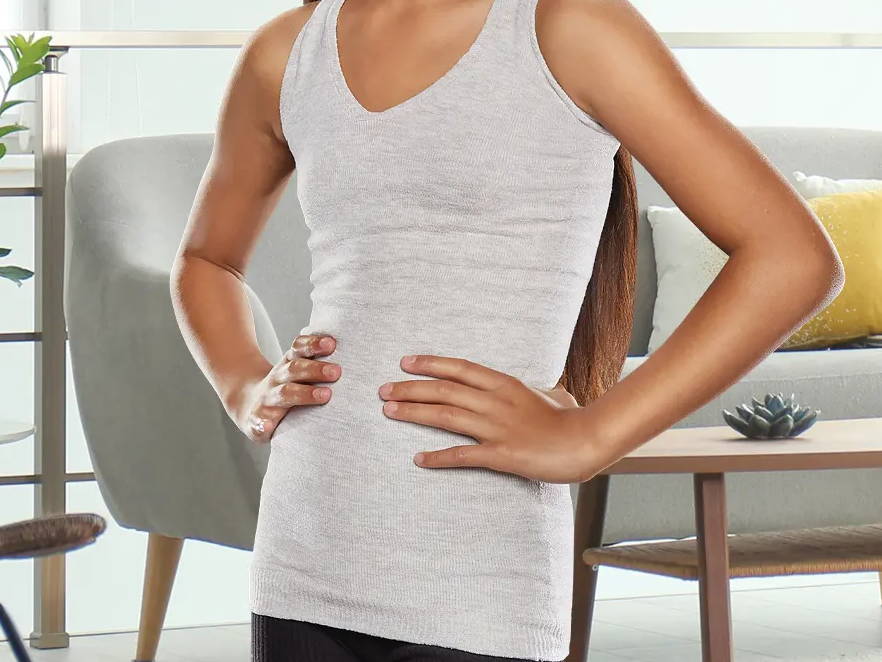 Female wearing Knit-Rite Torso Interface with Axilla Flap while in living room