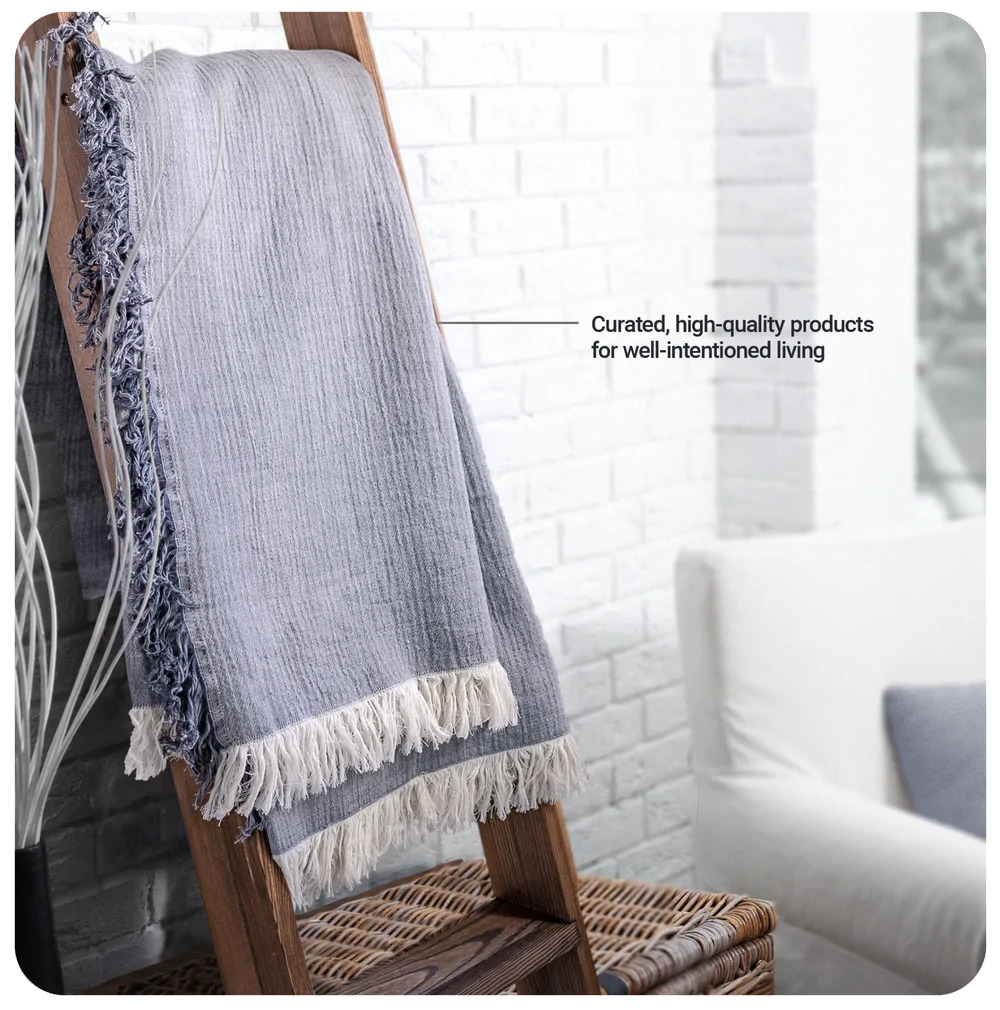 Fern fringe blanket draped over a stepladder. Curated, high-quality products for well-intentioned living.
