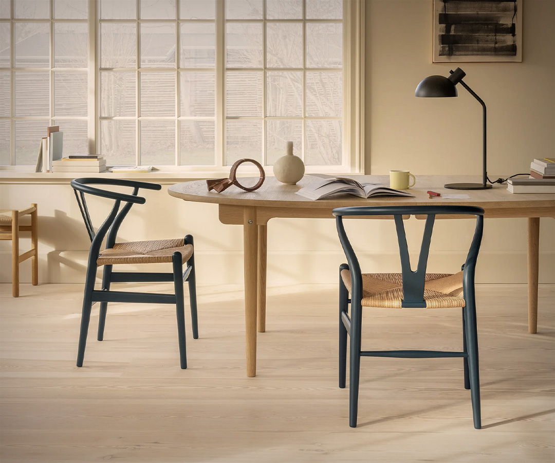 A stylish Carl Hansen room with a wooden table and chairs, featuring natural light.
