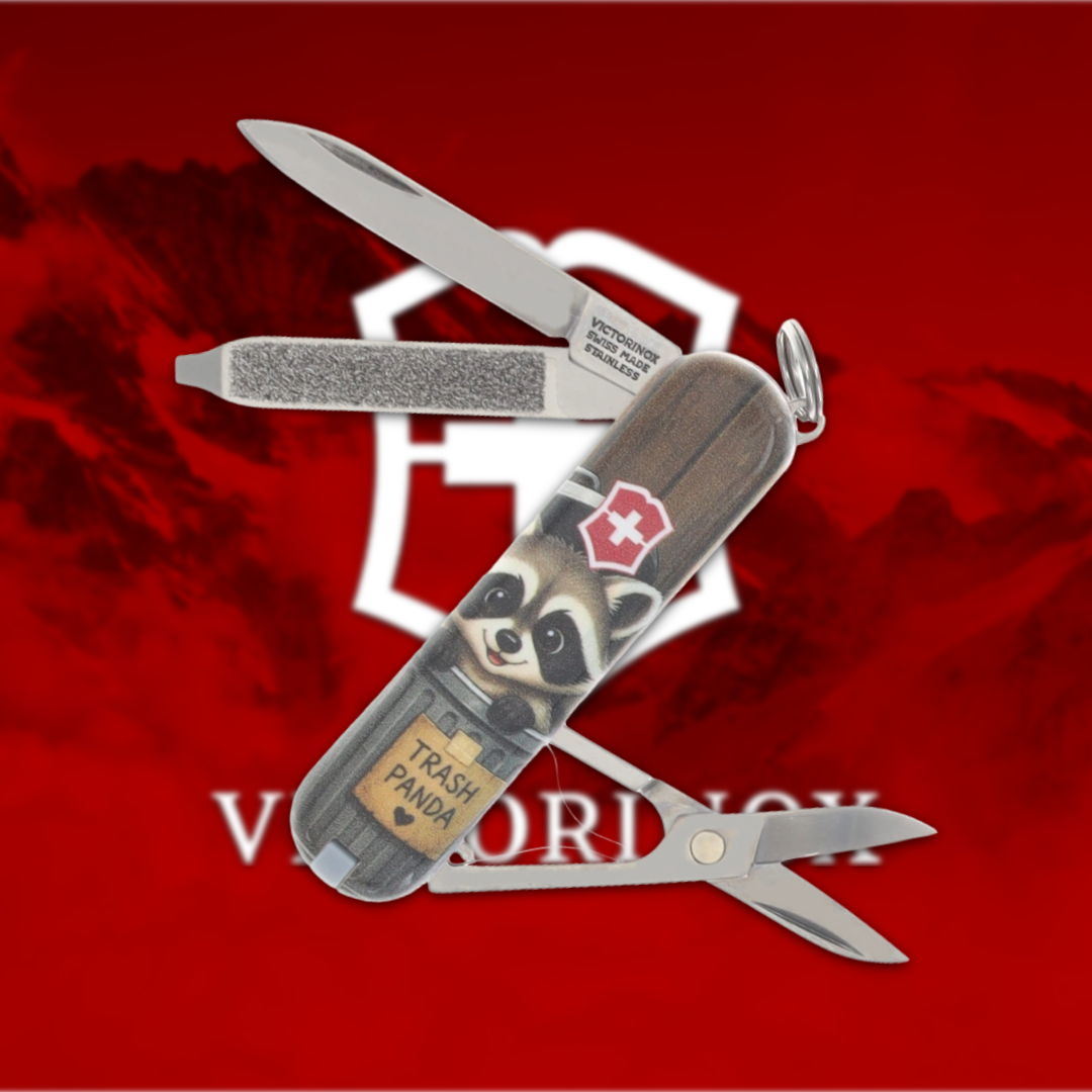 Victorinox Swiss Army knife with raccoon design on a red background.