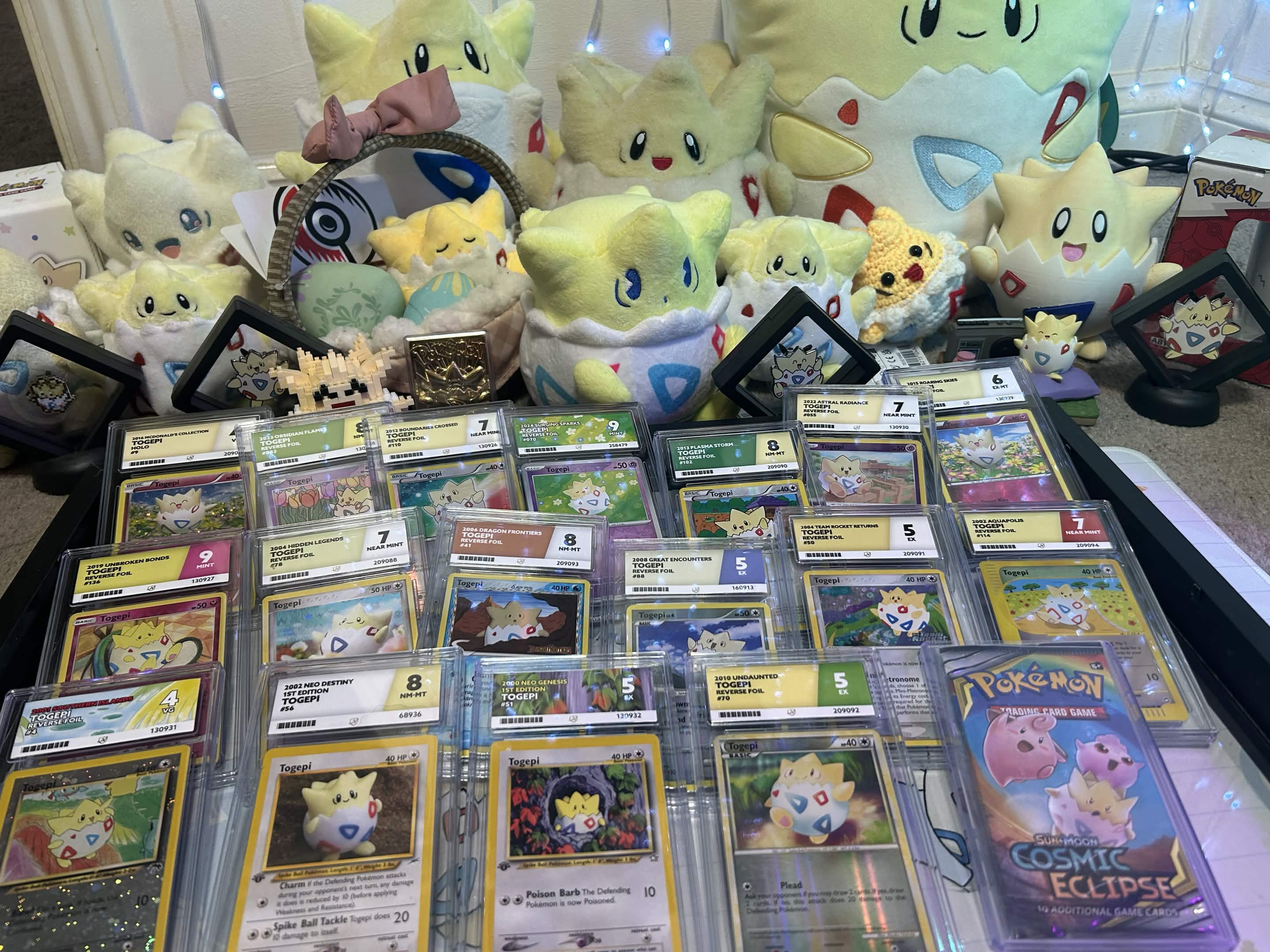 Collection of Pokémon cards and plush toys displayed together.