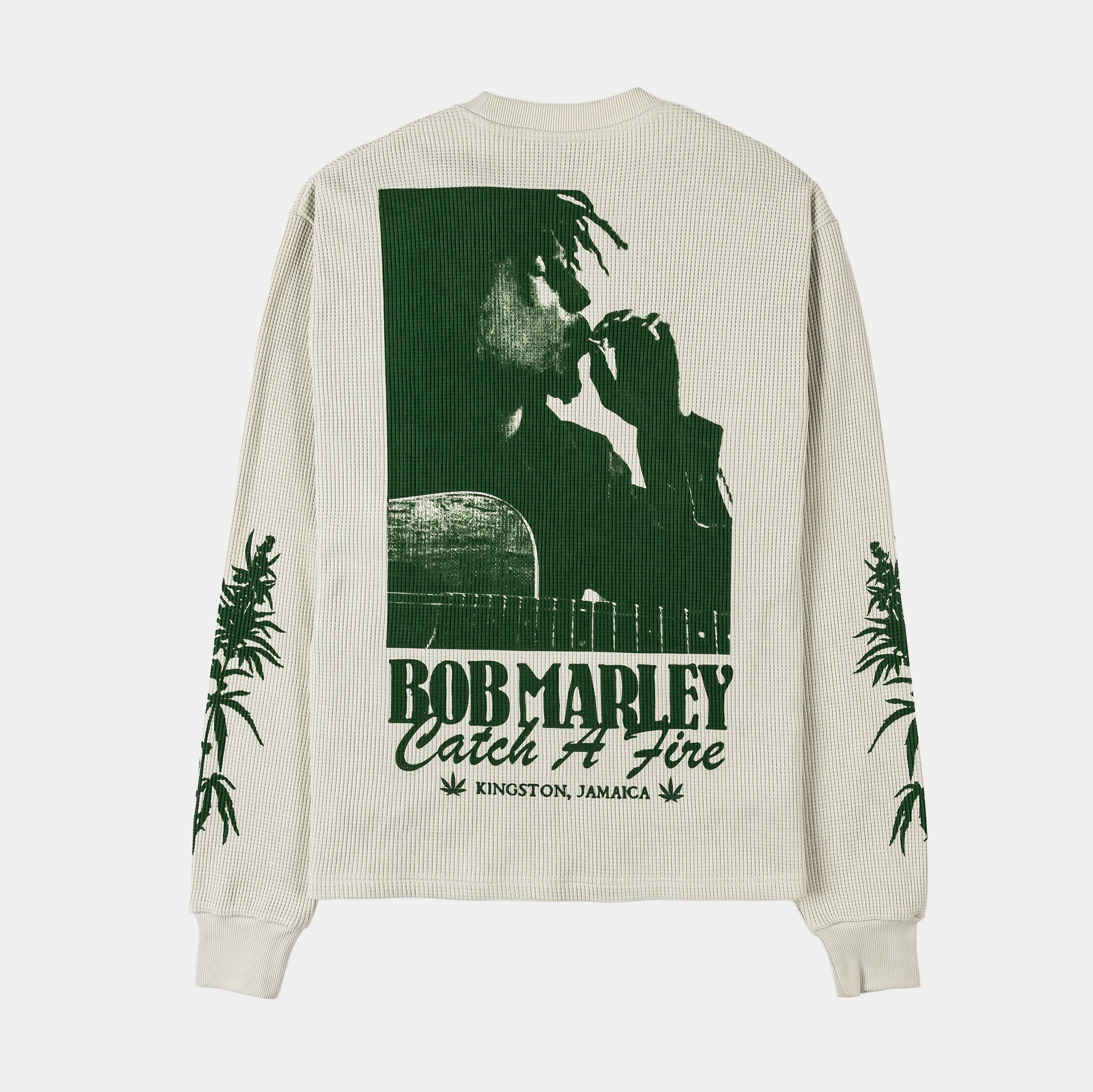 Long-sleeve shirt with green cannabis leaf designs on a light background.