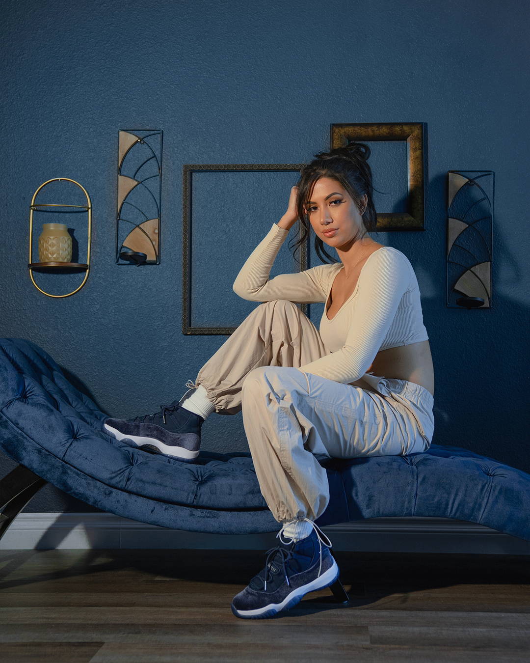 female model in aj11 retro midnight navy sitting on a chair