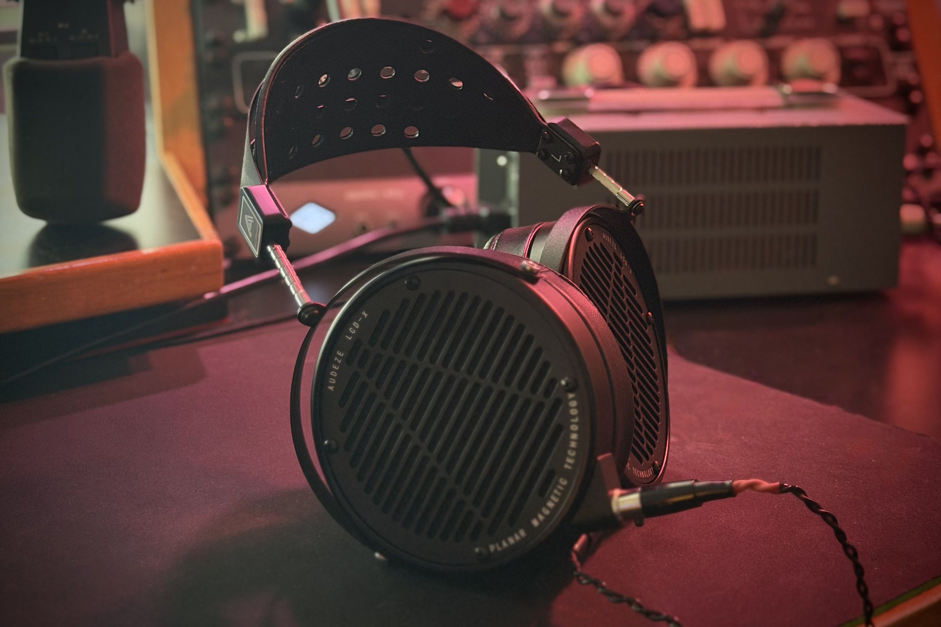 Audeze LCD-x headphones with a sleek design on a dark surface.