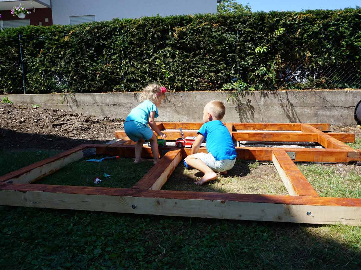 Two kids help to set up Kids Outdoor Playhouse by WholeWoodPlayhouses
