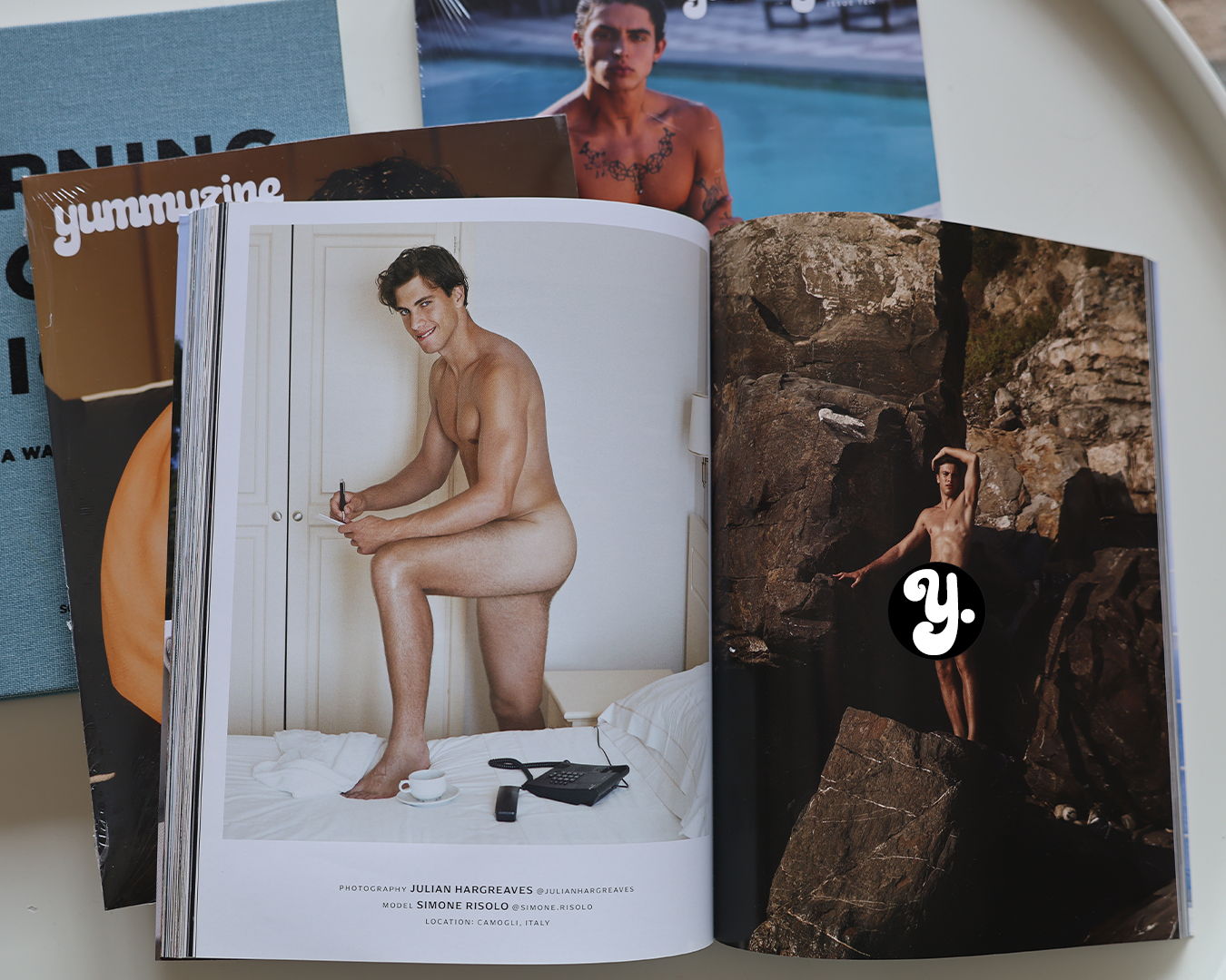A magazine open to a page featuring a nude male model.