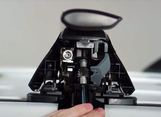 Side view of a roof rack leg being installed